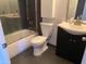This bathroom offers a bathtub with shower, toilet, and modern vanity with storage at 244 E Ponderosa Ln, Phoenix, AZ 85022