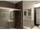 This bathroom is equipped with a glass door shower, a large mirror, and modern fixtures at 244 E Ponderosa Ln, Phoenix, AZ 85022