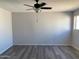 This spacious bedroom features a ceiling fan, wood-look flooring, and a neutral color scheme at 244 E Ponderosa Ln, Phoenix, AZ 85022