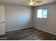 This bedroom has modern wood-look floors, a ceiling fan, and a window for natural light at 244 E Ponderosa Ln, Phoenix, AZ 85022