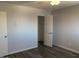This bedroom features neutral walls, wood-look flooring, and a spacious closet for ample storage at 244 E Ponderosa Ln, Phoenix, AZ 85022