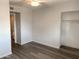 This bedroom is complete with wood-look floors, a ceiling fan, and closet with shelving at 244 E Ponderosa Ln, Phoenix, AZ 85022