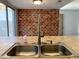 Close up on a kitchen sink with brick accent wall at 244 E Ponderosa Ln, Phoenix, AZ 85022