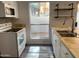 Kitchen featuring a sink, white cabinets, new flooring and stainless appliances at 244 E Ponderosa Ln, Phoenix, AZ 85022