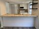 Open kitchen featuring stainless steel appliances, tile countertops and backsplash, and a convenient breakfast bar at 244 E Ponderosa Ln, Phoenix, AZ 85022