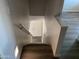 Carpeted staircase with handrail and step lights at 244 E Ponderosa Ln, Phoenix, AZ 85022