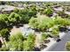 Neighborhood park with playground featuring a sunshade and surrounded by lush greenery at 2472 E Prescott Pl, Chandler, AZ 85249