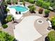 Aerial view of a backyard with a sparkling pool, seating, lush landscaping and fire pit at 2472 E Prescott Pl, Chandler, AZ 85249