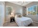 Bright bedroom with two windows, a side table, and built-in shelves at 2472 E Prescott Pl, Chandler, AZ 85249
