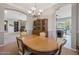 Elegant dining room with wood furniture and an open view into the living room and kitchen area at 2472 E Prescott Pl, Chandler, AZ 85249
