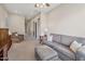 Neutral living room with couches, an ottoman, and a hall at 2472 E Prescott Pl, Chandler, AZ 85249