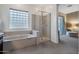 Luxurious main bathroom featuring a glass walk-in shower and a soaking tub at 2472 E Prescott Pl, Chandler, AZ 85249