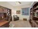 Comfortable office space featuring wood bookcases, a large desk, and a reading chair at 2472 E Prescott Pl, Chandler, AZ 85249