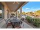 Covered patio with stylish outdoor furniture overlooks lush landscaping and private pool at 2472 E Prescott Pl, Chandler, AZ 85249