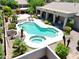Aerial view of a backyard featuring a stunning pool, spa, covered patio, and lush landscaping at 2472 E Prescott Pl, Chandler, AZ 85249