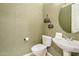 This powder room features elegant floral wallpaper, pedestal sink, and decorative hanging baskets at 2472 E Prescott Pl, Chandler, AZ 85249