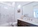 Well-lit bathroom with a modern vanity and a glass-enclosed shower offers a clean and sleek design at 2513 E Pleasant Ln, Phoenix, AZ 85042