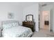 Comfortable bedroom with a plush bed, dark wood dresser, and a soothing ambiance for restful nights at 2513 E Pleasant Ln, Phoenix, AZ 85042