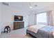 Well-lit bedroom features an entertainment center, neutral color scheme, and ample natural light at 2513 E Pleasant Ln, Phoenix, AZ 85042