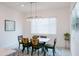 Bright dining area featuring a modern light fixture and a table set for Gathering meals at 2513 E Pleasant Ln, Phoenix, AZ 85042