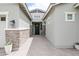 Inviting home entryway with brick pathway leading to a black front door and stylish exterior lighting at 2513 E Pleasant Ln, Phoenix, AZ 85042