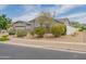 Single-story home with a well-manicured front yard featuring desert landscaping and a three-car garage at 2513 E Pleasant Ln, Phoenix, AZ 85042