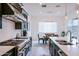 Bright, modern kitchen leading to dining area; features updated appliances and a sleek design at 2513 E Pleasant Ln, Phoenix, AZ 85042