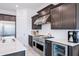 Well-equipped kitchen featuring stainless steel appliances, white countertops, and dark wood cabinets at 2513 E Pleasant Ln, Phoenix, AZ 85042
