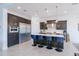 Modern kitchen featuring an island with seating, stainless appliances, and a bright, open layout at 2513 E Pleasant Ln, Phoenix, AZ 85042