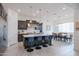 Bright modern kitchen boasts an island with seating, stainless appliances, and dark wood cabinets at 2513 E Pleasant Ln, Phoenix, AZ 85042