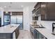 Well-equipped kitchen featuring stainless steel appliances, white countertops, and dark wood cabinets at 2513 E Pleasant Ln, Phoenix, AZ 85042