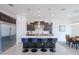 Bright modern kitchen boasts an island with seating, stainless appliances, and dark wood cabinets at 2513 E Pleasant Ln, Phoenix, AZ 85042