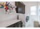Bright laundry room with a washer, dryer, ample storage, and counter space for folding at 2513 E Pleasant Ln, Phoenix, AZ 85042
