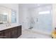 A luxurious main bathroom with a glass-enclosed shower, marble tile, and vanity at 2513 E Pleasant Ln, Phoenix, AZ 85042
