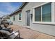 Backyard patio features a brick paver floor and textured stucco walls on the home's exterior at 2513 E Pleasant Ln, Phoenix, AZ 85042