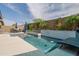 A sparkling pool features a raised tiled wall and is surrounded by lush landscaping in this backyard oasis at 2513 E Pleasant Ln, Phoenix, AZ 85042