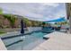Backyard pool with blue accents, concrete pool deck, and outdoor seating area with blue sunshade at 2513 E Pleasant Ln, Phoenix, AZ 85042
