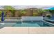 Sparkling pool area is surrounded by lush landscaping, lounge chairs, and stylish mosaic walls for ultimate relaxation at 2513 E Pleasant Ln, Phoenix, AZ 85042