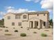 Expansive two-story home showcasing a stucco exterior, tiled roof, and a spacious front yard with desert landscaping at 26205 N 19Th Ln, Phoenix, AZ 85085