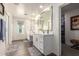 Spacious bathroom with double sinks, framed mirror, walk in closet and a separate shower at 29491 N 122Nd Gln, Peoria, AZ 85383