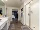 Bathroom featuring stylish wood-look floors, white vanity, and glass-enclosed shower at 29491 N 122Nd Gln, Peoria, AZ 85383