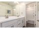 Bright bathroom with double sinks, framed mirror and shower-tub combination at 29491 N 122Nd Gln, Peoria, AZ 85383