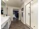Bathroom featuring stylish wood-look floors, white vanity, and glass-enclosed shower at 29491 N 122Nd Gln, Peoria, AZ 85383