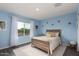 Light-filled bedroom with a bed, a window view, and neutral-colored accents at 29491 N 122Nd Gln, Peoria, AZ 85383