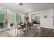 Elegant dining area with a rustic table, seating for six, and sliding glass doors to patio at 29491 N 122Nd Gln, Peoria, AZ 85383