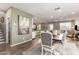 Open-concept view of kitchen, dining room with modern table set, and living area at 29491 N 122Nd Gln, Peoria, AZ 85383