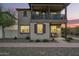 Attractive home exterior with a welcoming porch and manicured gravel landscaping at dusk at 29491 N 122Nd Gln, Peoria, AZ 85383