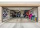Spacious garage with shelving and shoe racks for extra storage at 29491 N 122Nd Gln, Peoria, AZ 85383