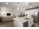 Bright, open kitchen featuring a granite island, stainless appliances, and a view into dining area at 29491 N 122Nd Gln, Peoria, AZ 85383