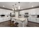 Modern kitchen with a large granite island, stainless steel appliances, and stylish pendant lighting at 29491 N 122Nd Gln, Peoria, AZ 85383